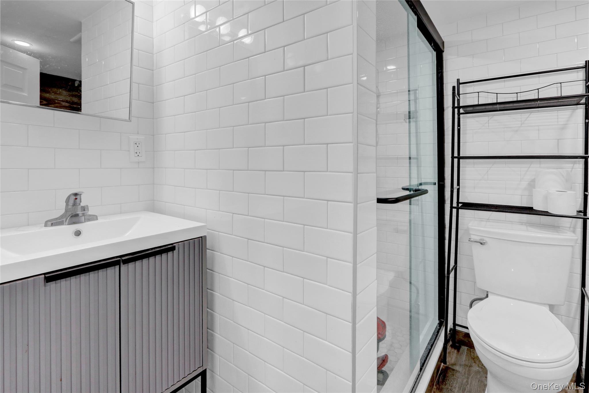 243 Lakeside Trail Ridge, NY 11961 - Photo 20 of 38 a bathroom with a sink toilet and shower