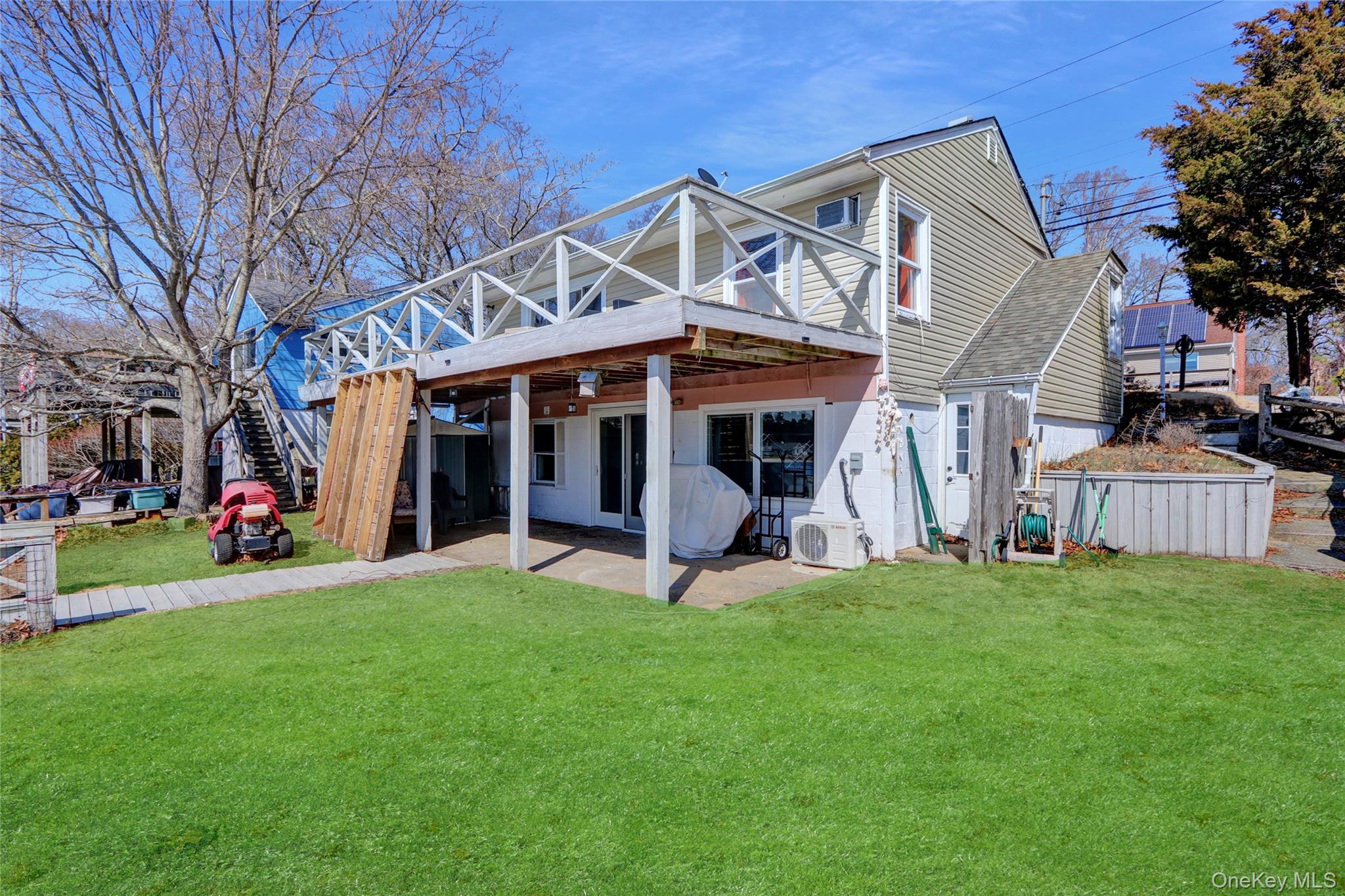 243 Lakeside Trail Ridge, NY 11961 - Photo 24 of 38 a view of a house with a yard and sitting area