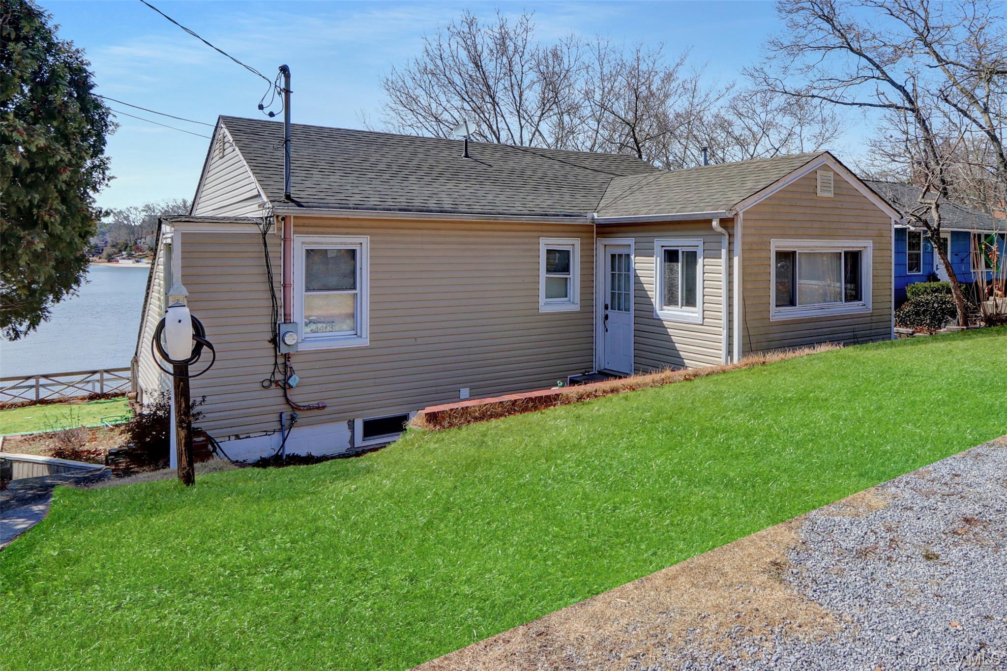 243 Lakeside Trail Ridge, NY 11961 - Photo 3 of 38 a front view of house with yard and green space