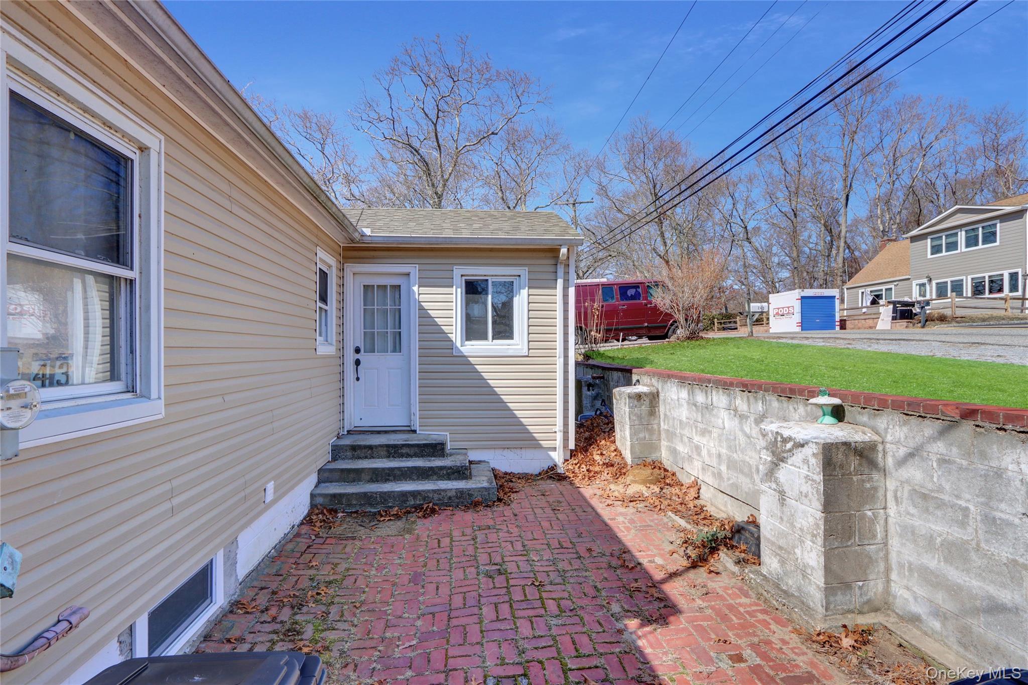 243 Lakeside Trail Ridge, NY 11961 - Photo 4 of 38 a view of a house with a yard