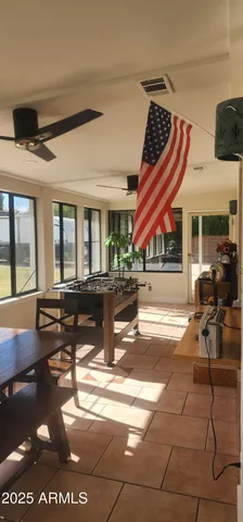 a living room with furniture a rug and white walls