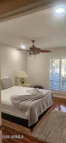 a bedroom with a bed and a large window