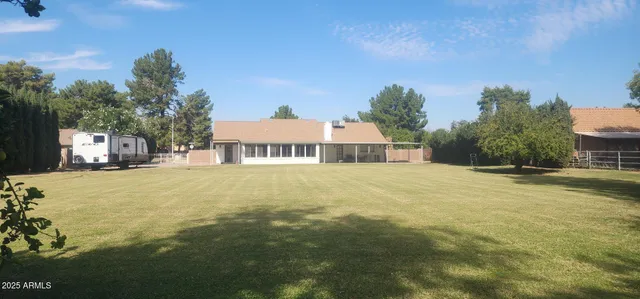 a view of an house with swimming pool and yard