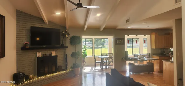 a living room with fireplace furniture dining table and a fireplace