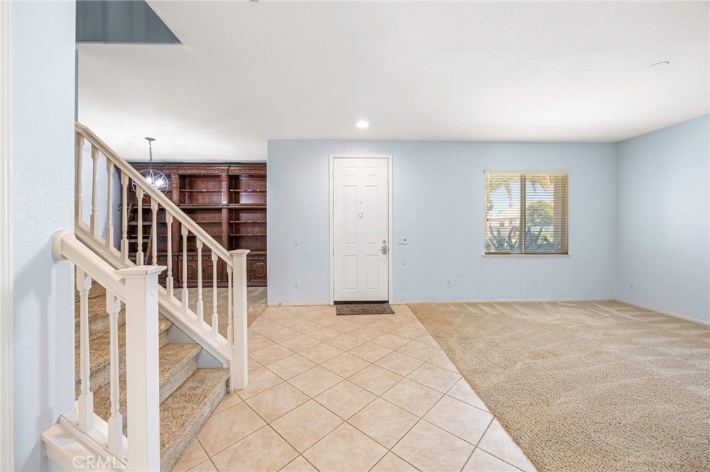 151 Ropango Way Hemet, CA 92545 - Photo 6 of 28 a view of an empty room with stairs and a window