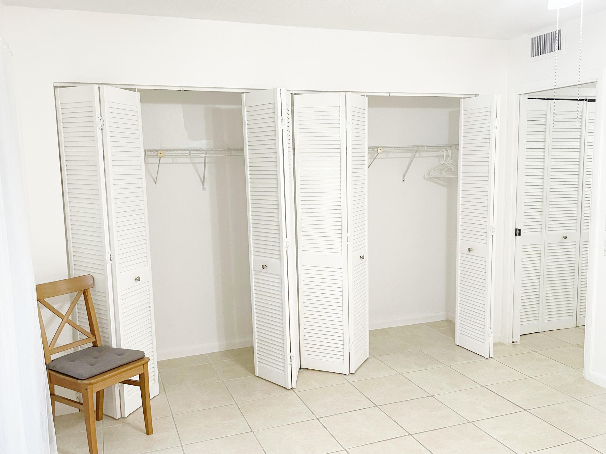 171 Suffolk F, Unit 171 Boca Raton, FL 33434 - Photo 13 of 21 a view of room with walk in closet with wooden floor
