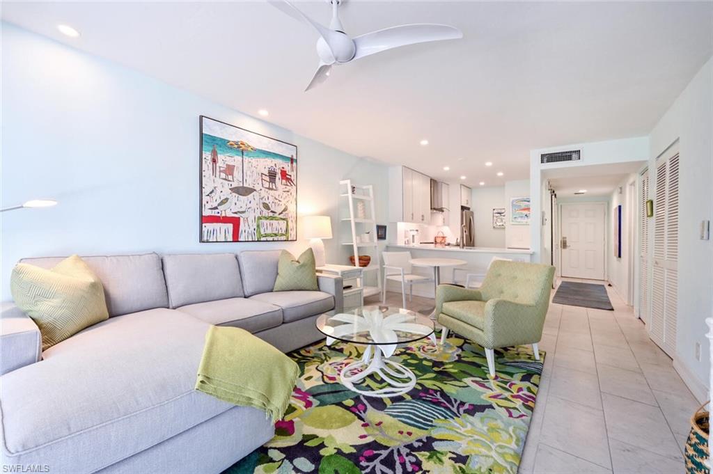 600 Neapolitan Way, Unit 107 Naples, FL 34103 - Photo 1 of 25 a living room with furniture and a rug