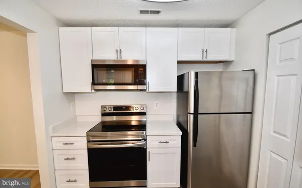 a white refrigerator freezer sitting in a kitchen