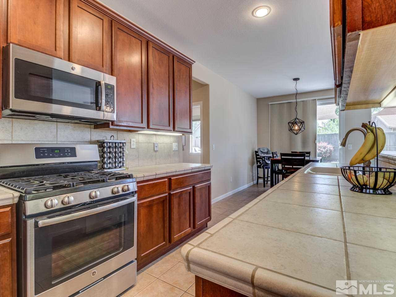460 Miesque Court Reno, NV 89521 - Photo 12 of 25 a kitchen with stainless steel appliances a stove a sink and a microwave