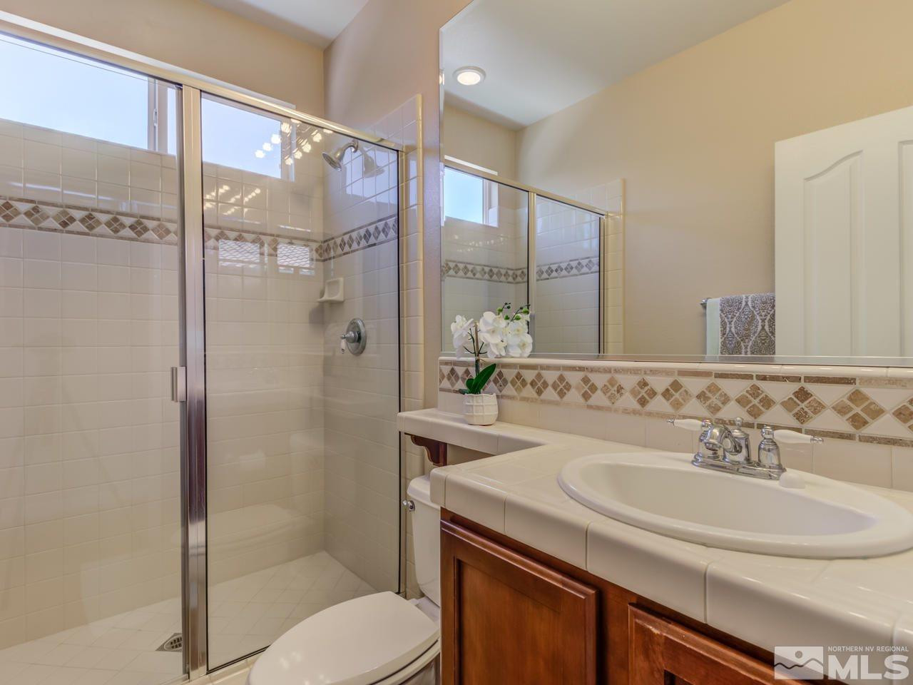 460 Miesque Court Reno, NV 89521 - Photo 14 of 25 a bathroom with a sink toilet double vanity and shower