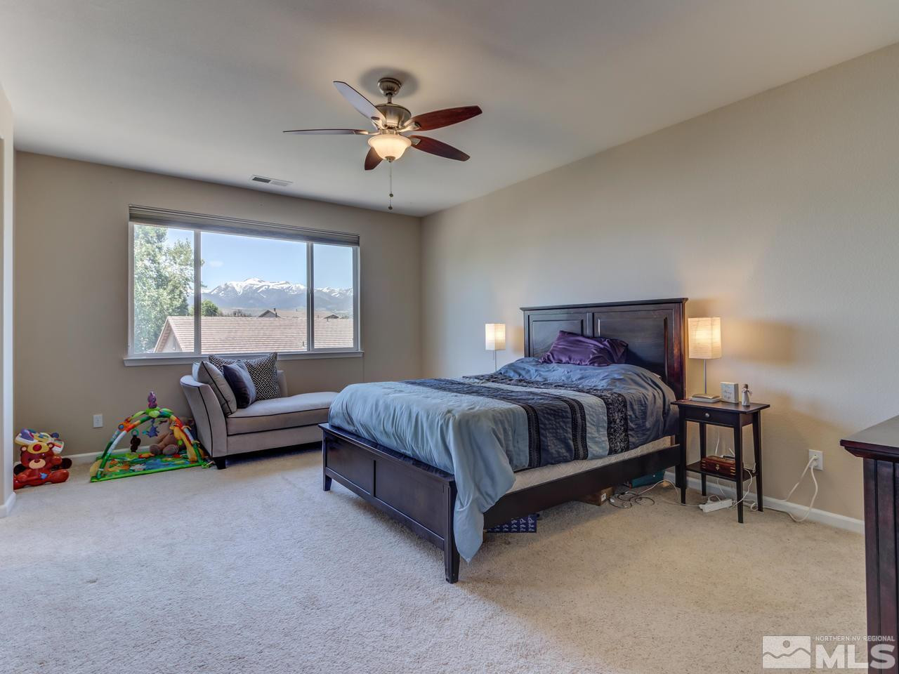 460 Miesque Court Reno, NV 89521 - Photo 17 of 25 a bedroom with a bed couch and window