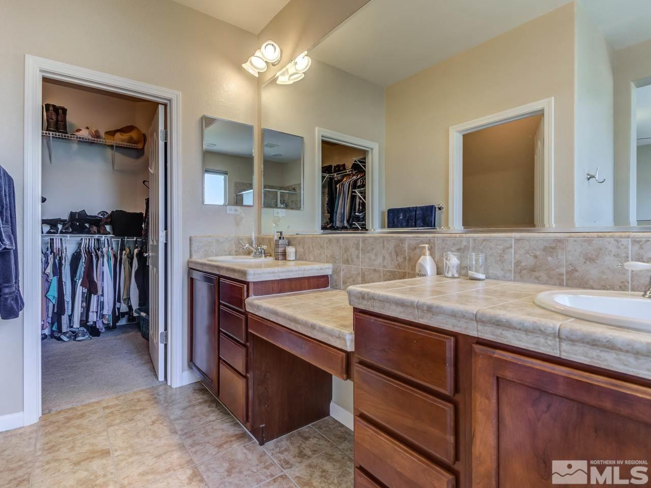 460 Miesque Court Reno, NV 89521 - Photo 19 of 25 a en suite bathroom with a granite countertop sink and a mirror