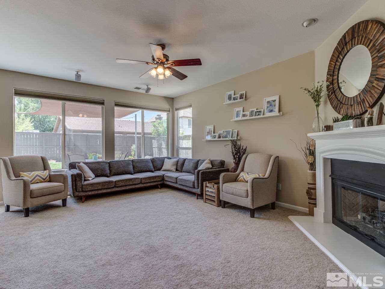 460 Miesque Court Reno, NV 89521 - Photo 6 of 25 a living room with furniture a fireplace and a large window
