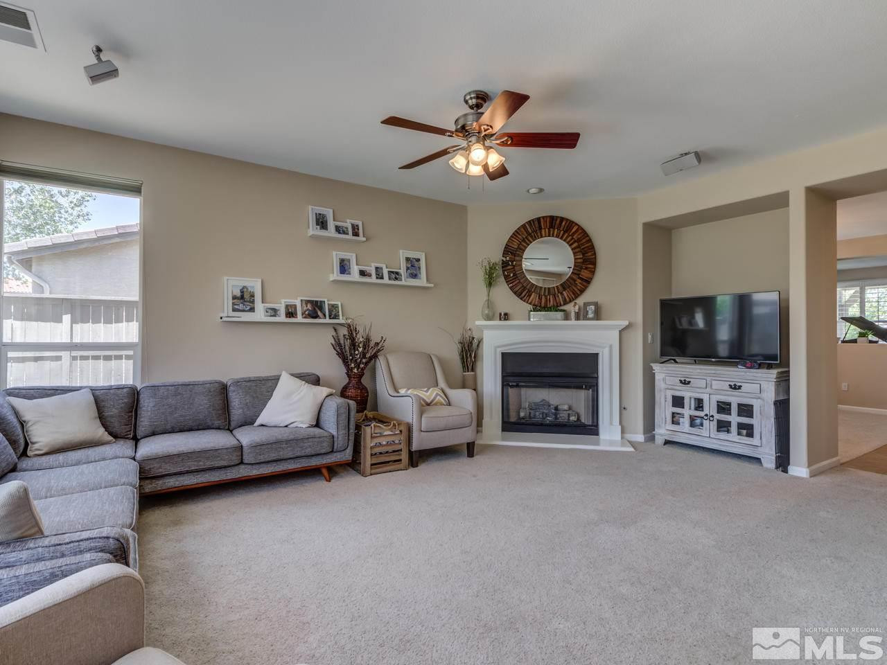 460 Miesque Court Reno, NV 89521 - Photo 7 of 25 a living room with furniture a fireplace and a flat screen tv