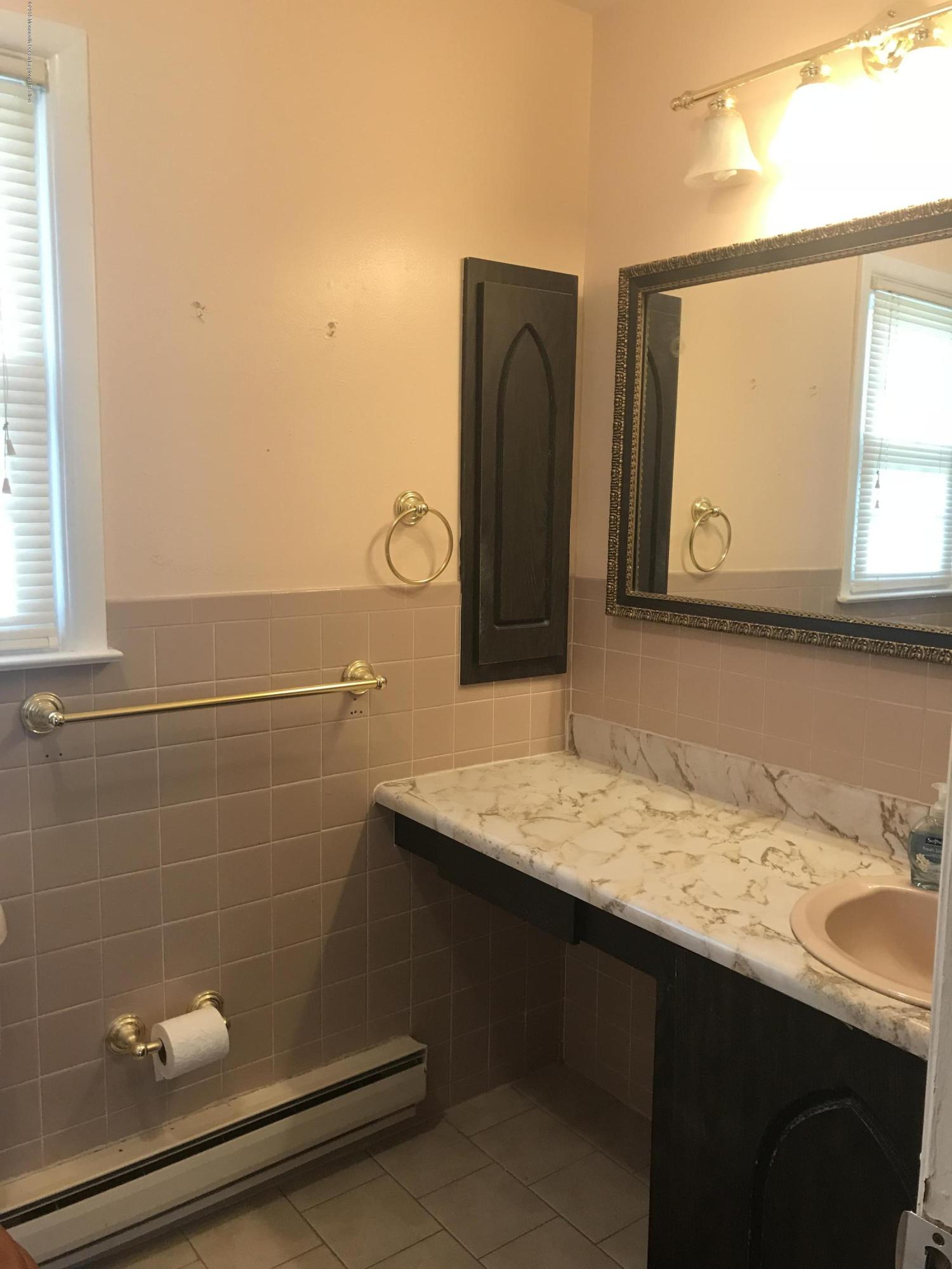 16 Masters Road Brick, NJ 08724 - Photo 4 of 11 a bathroom with a sink and a mirror