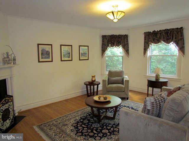 4815 Keswick Road Baltimore, MD 21210 - Photo 11 of 30 a living room with furniture and a chandelier