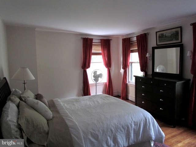4815 Keswick Road Baltimore, MD 21210 - Photo 16 of 30 a bedroom with a bed and a closet with mirror