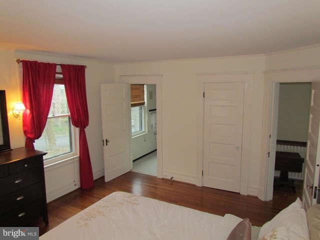 4815 Keswick Road Baltimore, MD 21210 - Photo 17 of 30 wooden floor with windows and cabinet