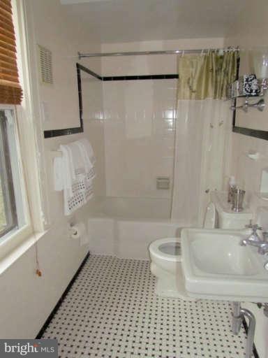 4815 Keswick Road Baltimore, MD 21210 - Photo 18 of 30 a bathroom with a bathtub and a shower