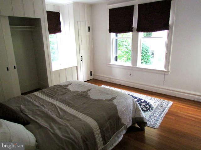 4815 Keswick Road Baltimore, MD 21210 - Photo 21 of 30 a bed sitting in a bedroom next to a window