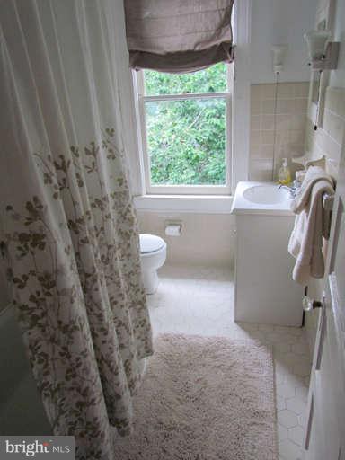 4815 Keswick Road Baltimore, MD 21210 - Photo 23 of 30 a bathroom with a sink a toilet and a tub