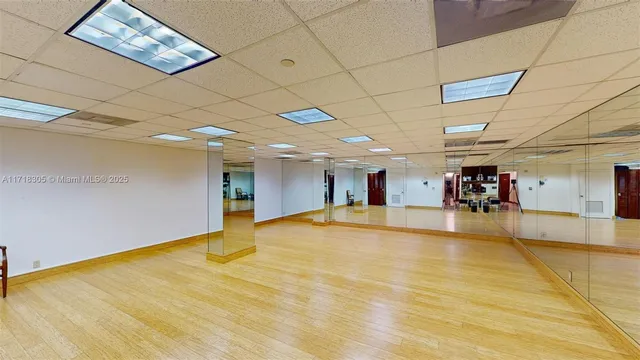 a bathroom with a glass door shower and a table