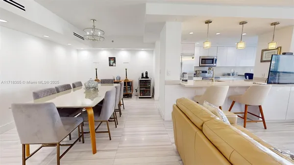 a kitchen with a faucet a chandelier and living room view