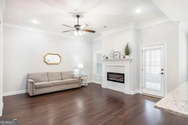 a large kitchen with stainless steel appliances kitchen island granite countertop a refrigerator a stove a sink and a wooden floors