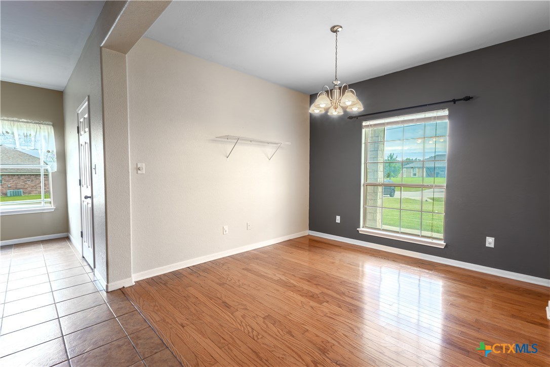 283 County Road 4710 Kempner, TX 76539 - Photo 11 of 47 a view of an empty room with wooden floor fridge and a window