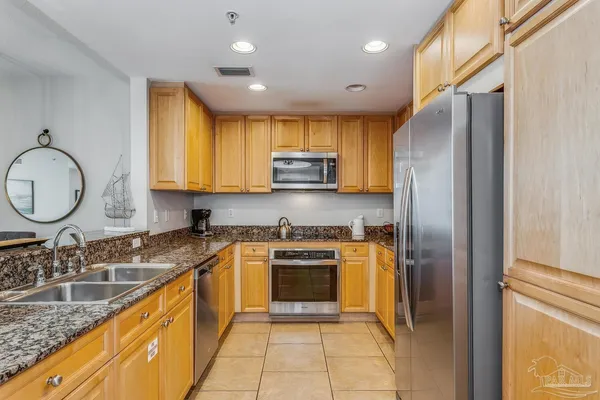 a kitchen with a stove microwave refrigerator and cabinets