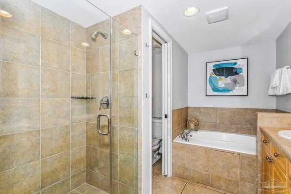 a bathroom with a granite countertop sink mirror and bathtub