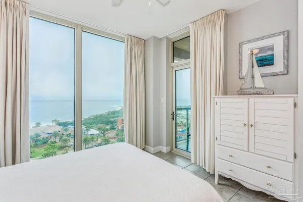 a bedroom with a bed and a lamp on table