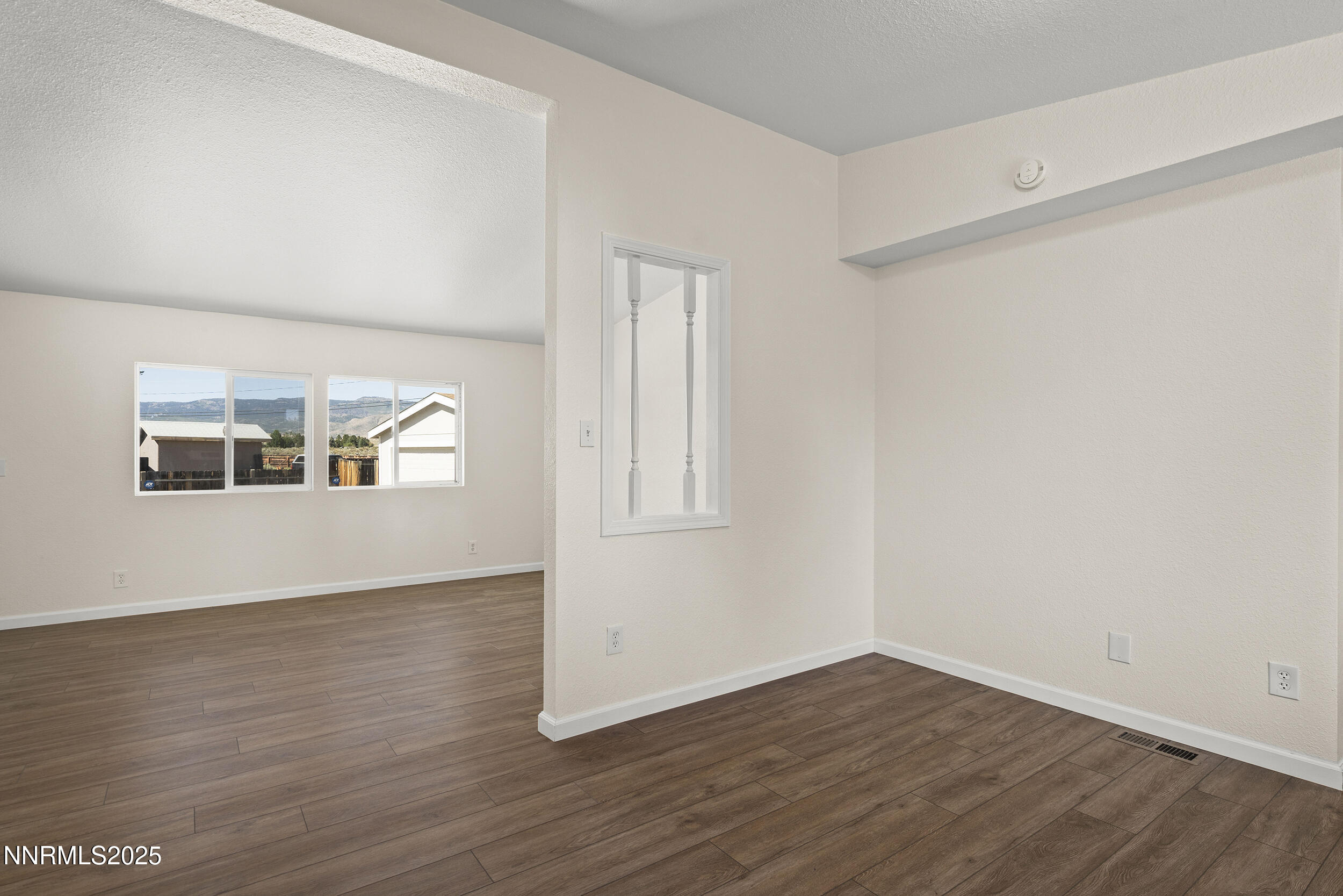 17855 Blackbird Drive Reno, NV 89508 - Photo 11 of 26 an empty room with wooden floor and windows