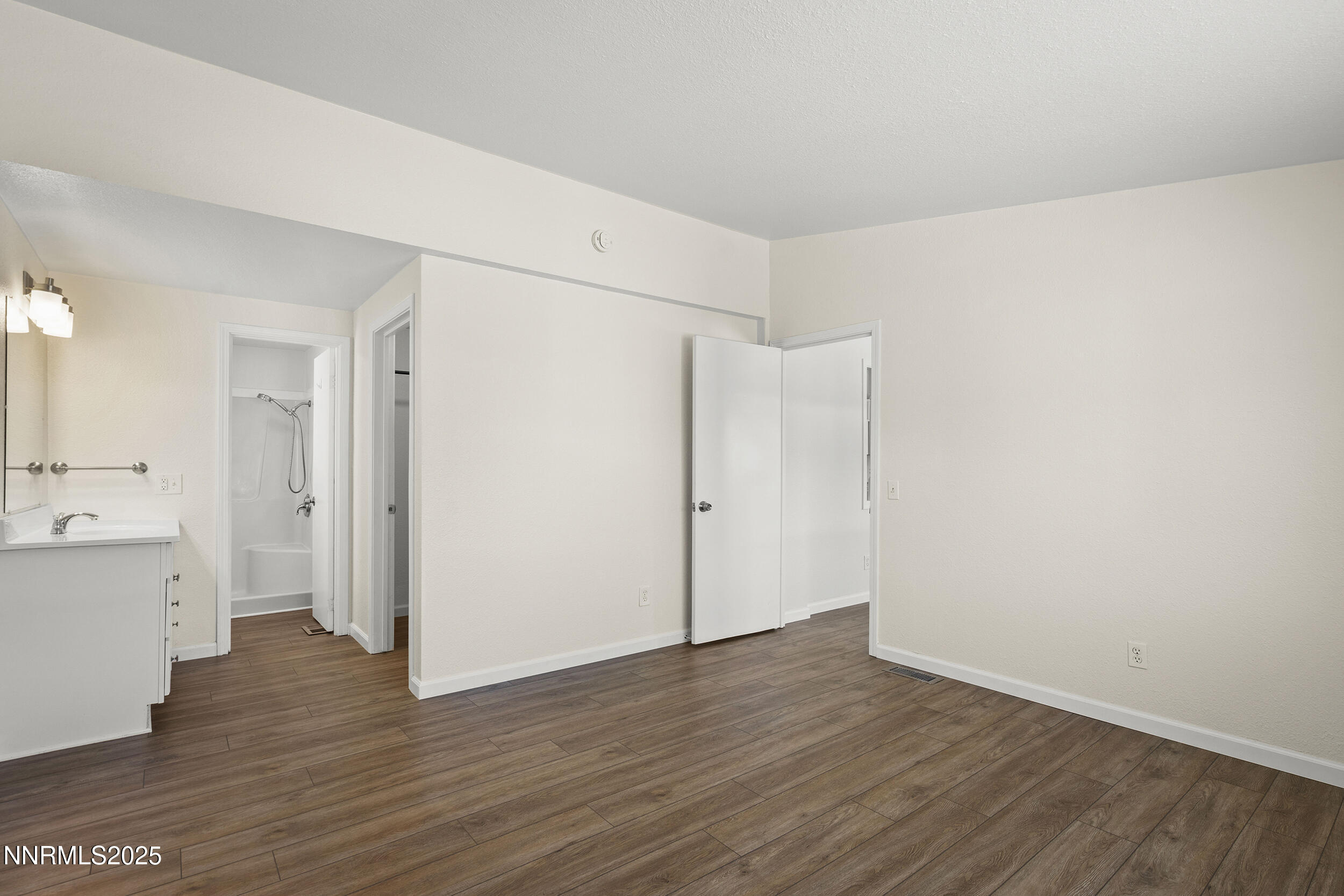 17855 Blackbird Drive Reno, NV 89508 - Photo 13 of 26 a view of an empty room with wooden floor and a window
