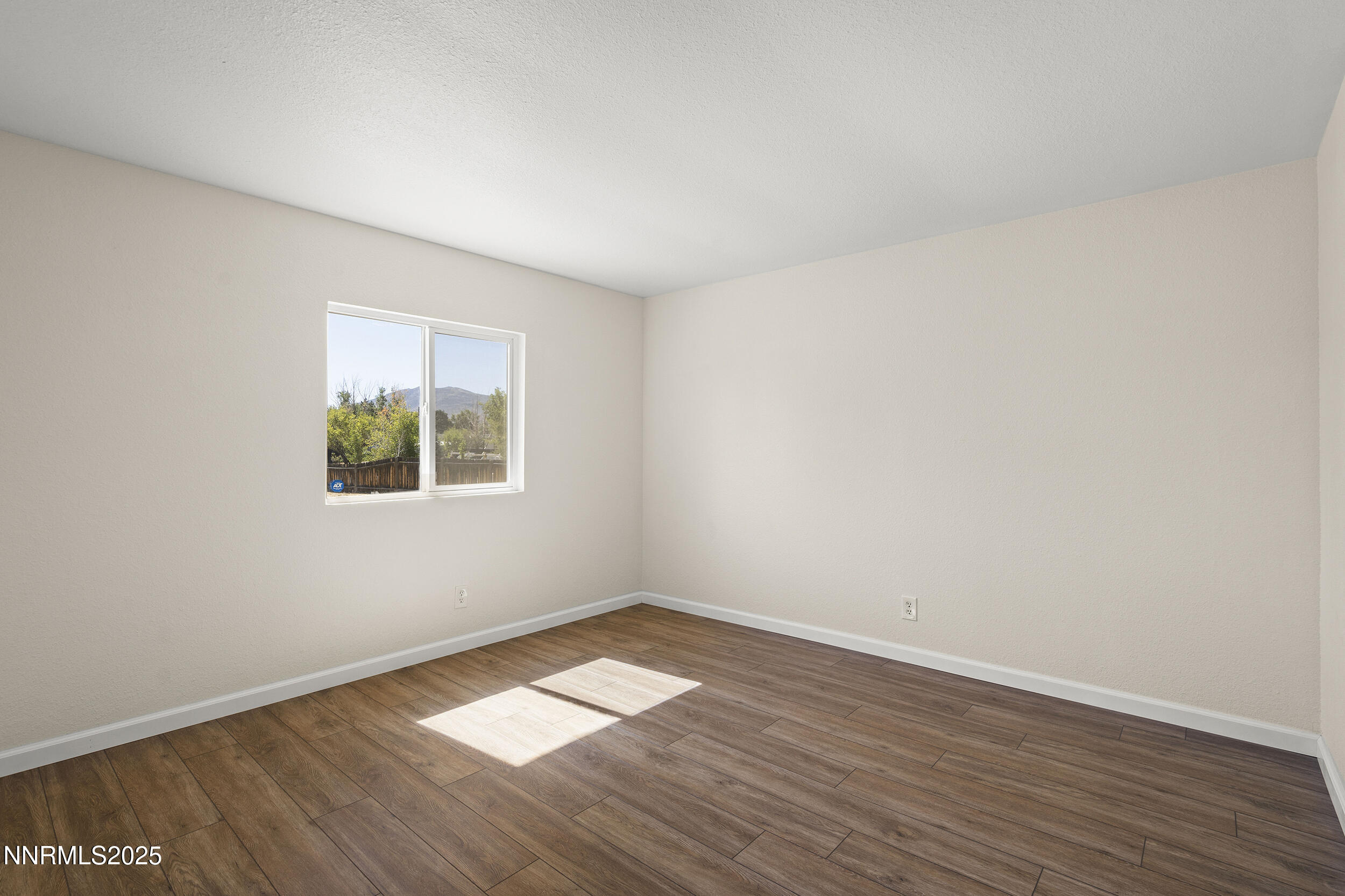 17855 Blackbird Drive Reno, NV 89508 - Photo 17 of 26 an empty room with wooden floor and windows