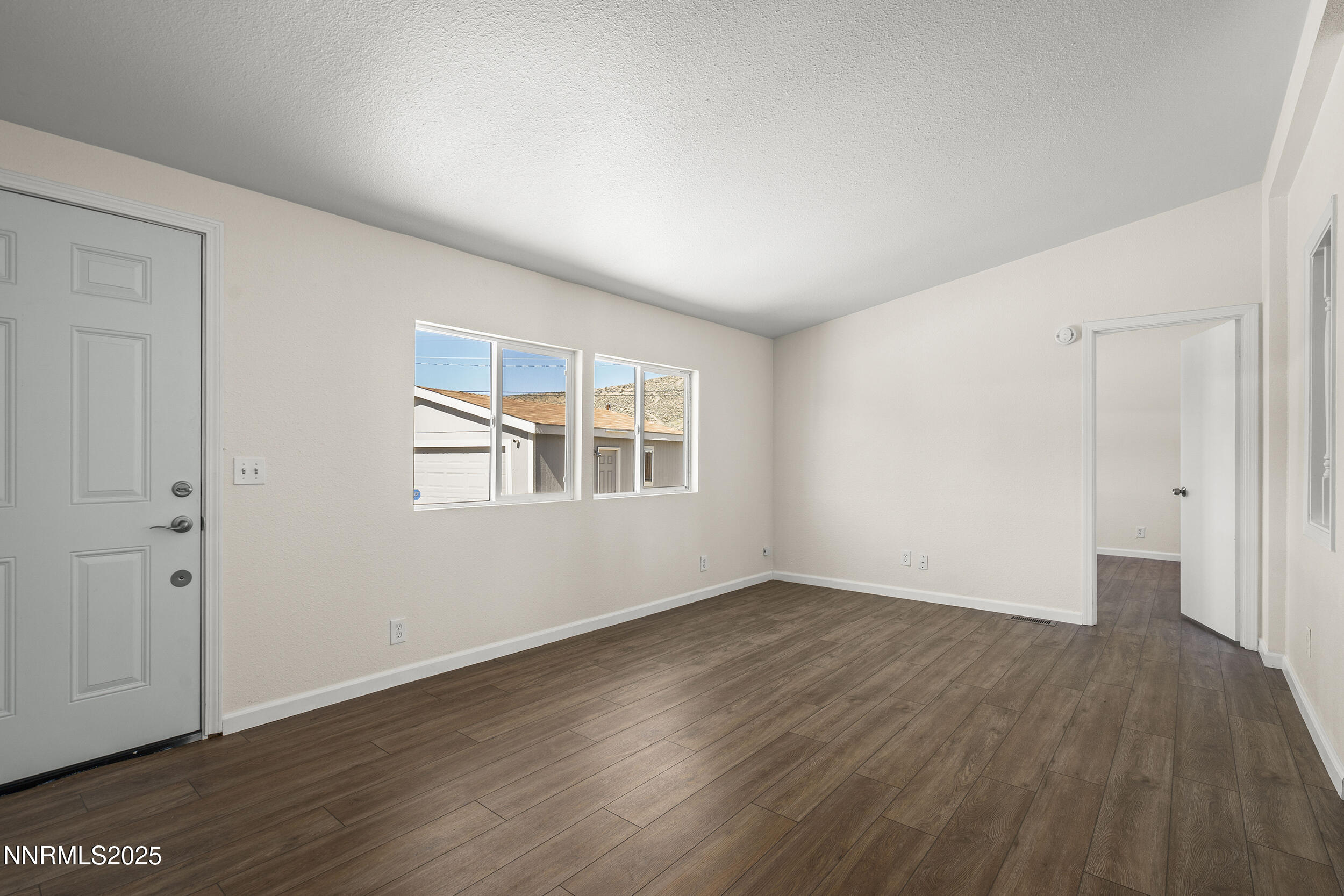 17855 Blackbird Drive Reno, NV 89508 - Photo 4 of 26 a view of an empty room with wooden floor and a window