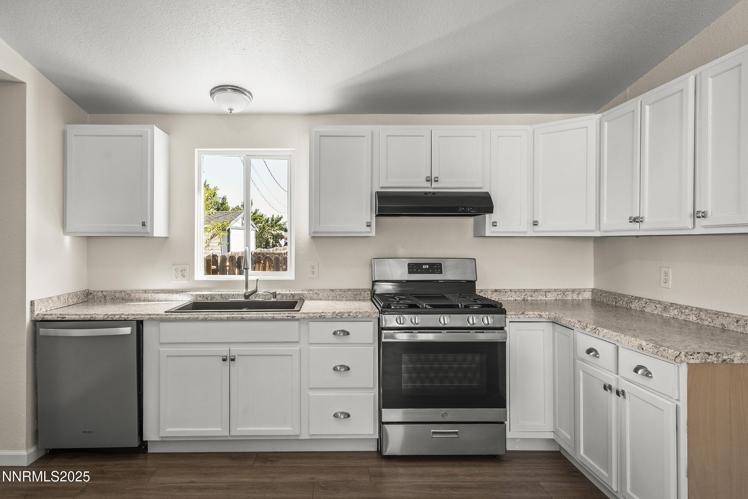 17855 Blackbird Drive Reno, NV 89508 - Photo 7 of 26 a kitchen with stainless steel appliances granite countertop a stove a sink and a microwave
