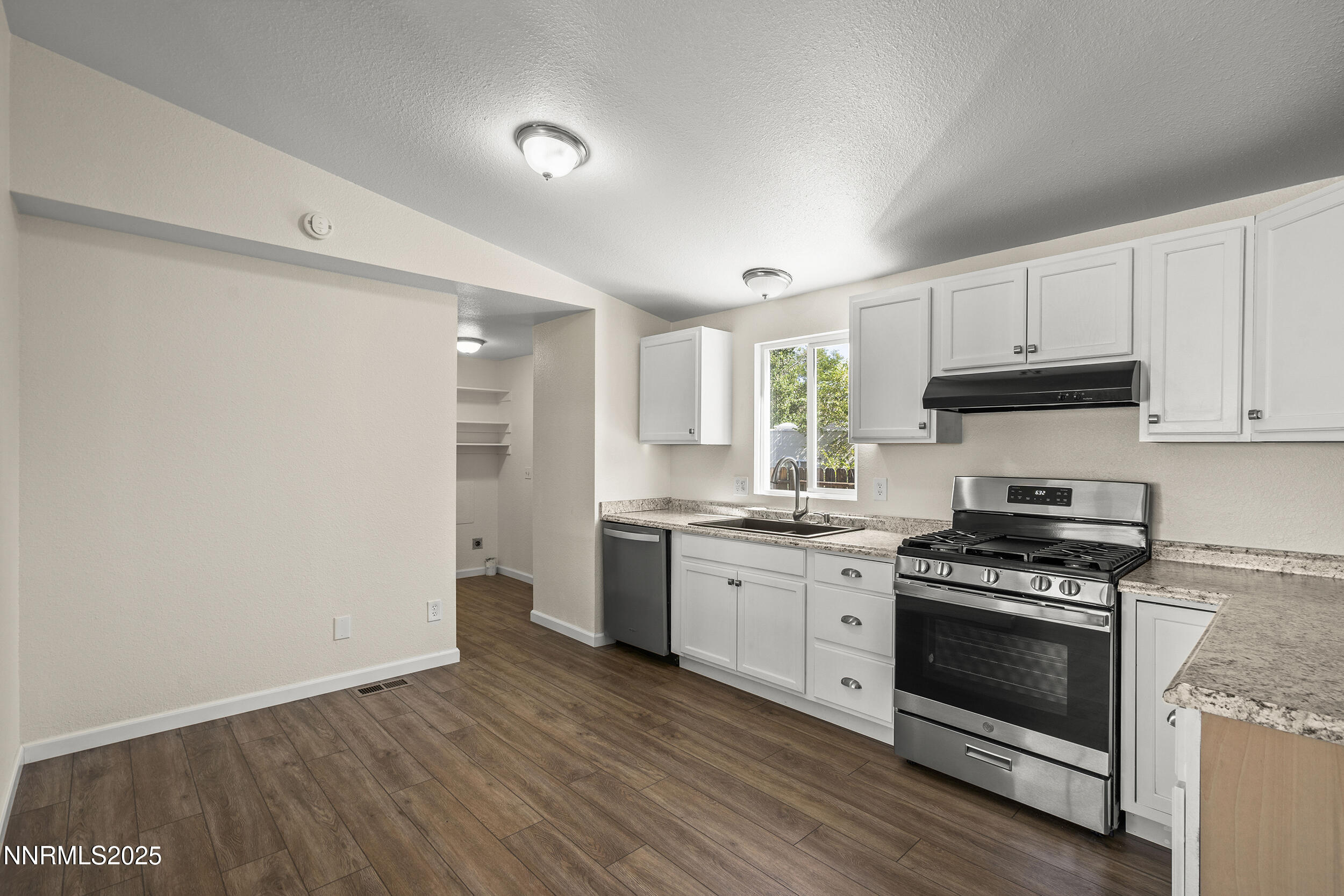 17855 Blackbird Drive Reno, NV 89508 - Photo 8 of 26 a kitchen with granite countertop a stove top oven and cabinets