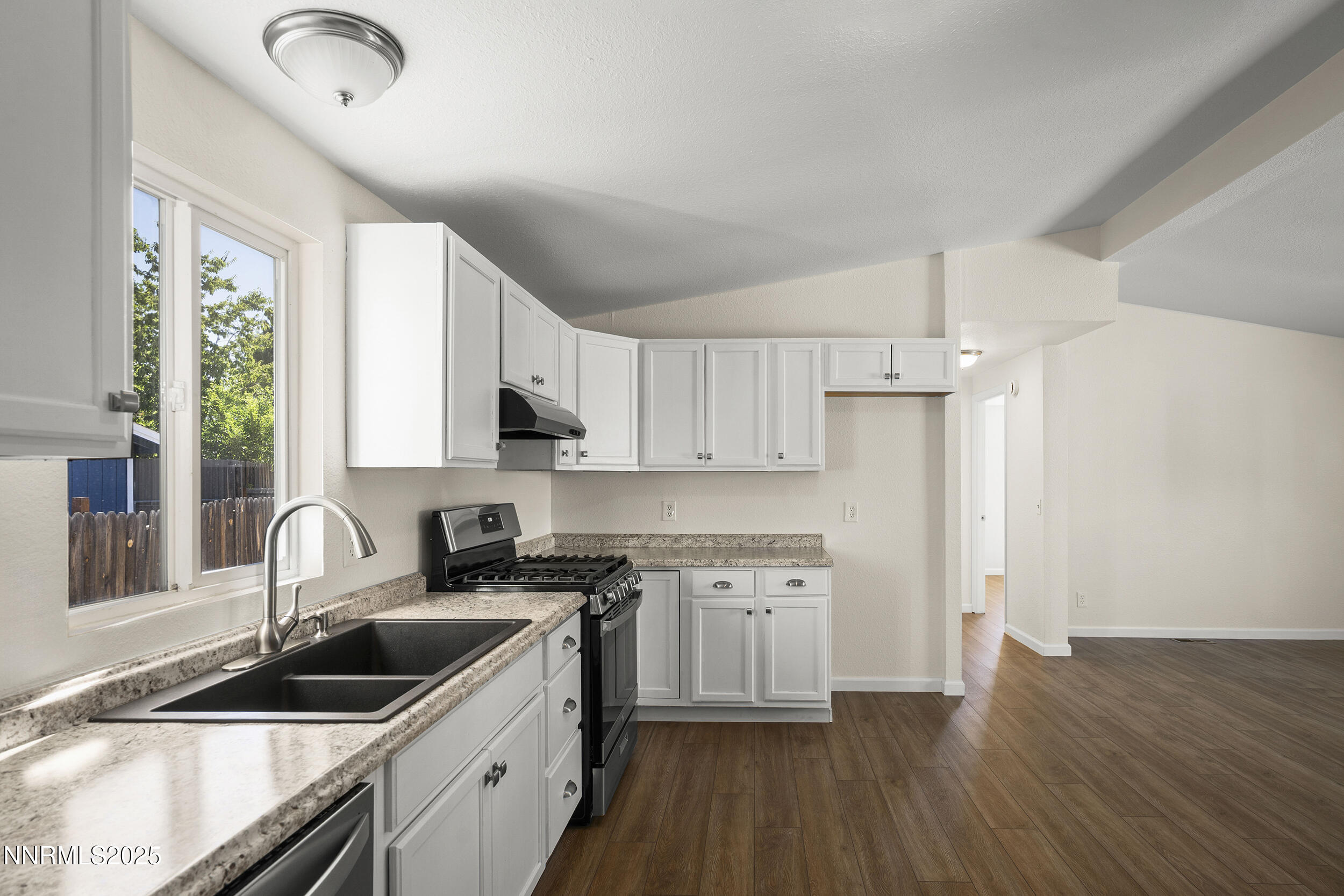 17855 Blackbird Drive Reno, NV 89508 - Photo 10 of 26 a kitchen with granite countertop a sink cabinets a counter top space and stainless steel appliances