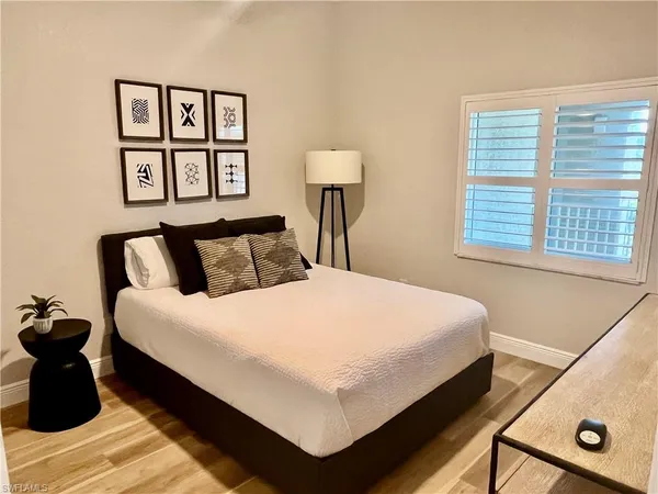 a bedroom with bed and night stand