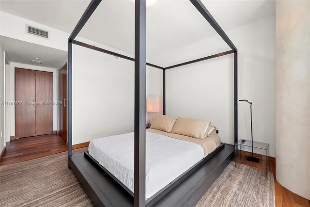 a bed sitting in a bedroom next to a window
