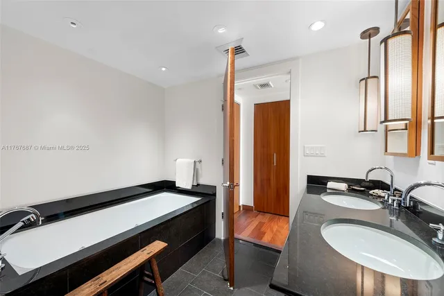 a en suite bathroom with a sink double vanity and a mirror