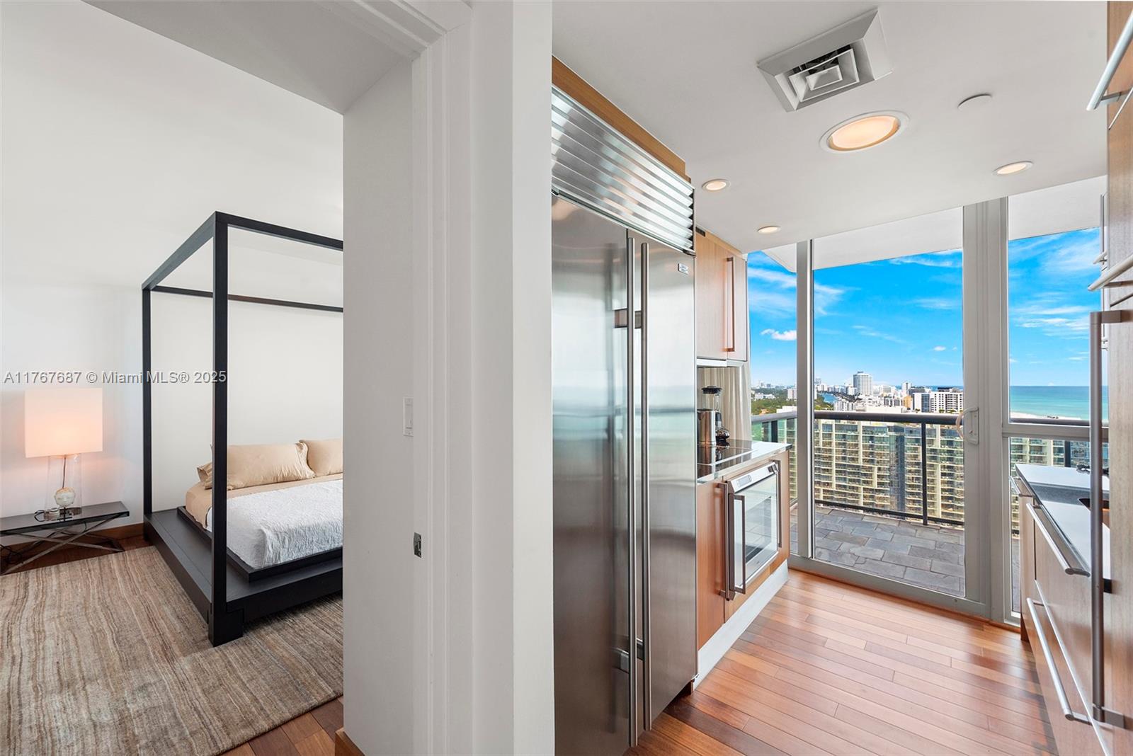 101 20th Street, Unit 3105 Miami Beach, FL 33139 - Photo 30 of 34 a view of a hallway view with living room and wooden floor