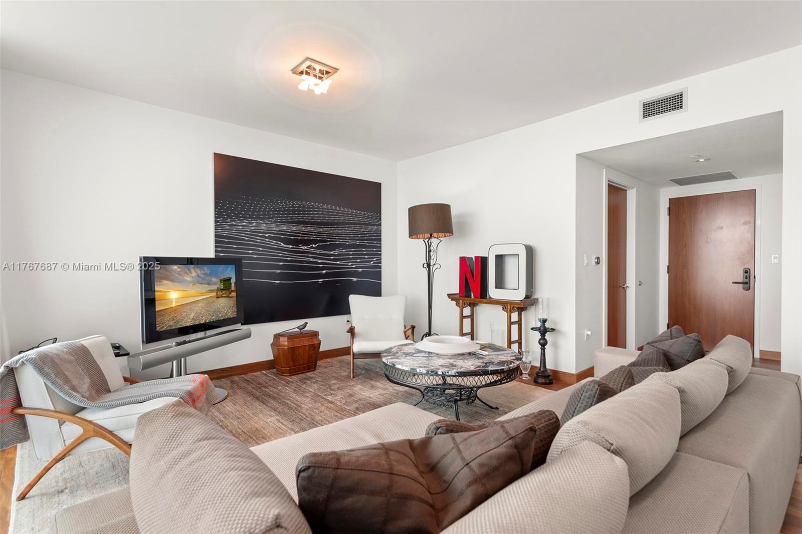 101 20th Street, Unit 3105 Miami Beach, FL 33139 - Photo 5 of 34 a living room with furniture and a flat screen tv