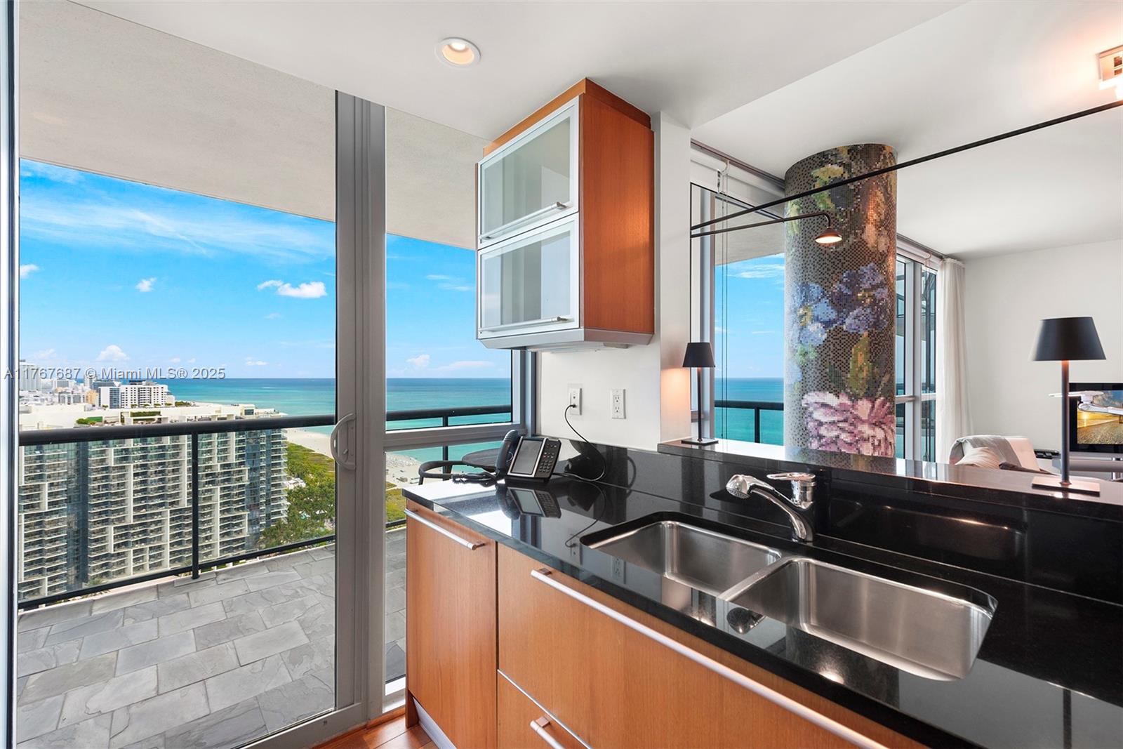 101 20th Street, Unit 3105 Miami Beach, FL 33139 - Photo 6 of 34 a kitchen with a sink and a refrigerator