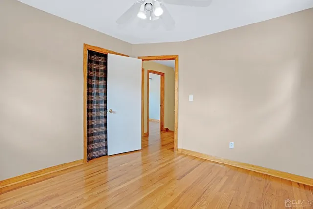 an empty room with wooden floor and closet