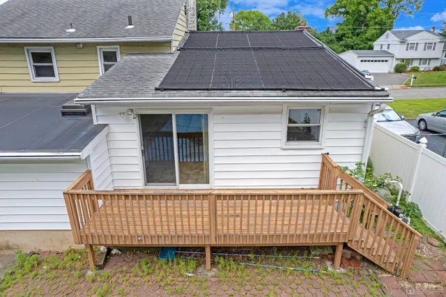 a view of a house with a yard and deck
