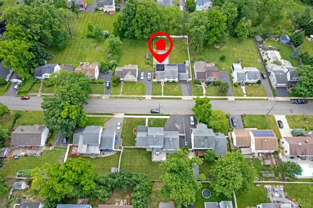 an aerial view of a house with swimming pool outdoor seating and yard
