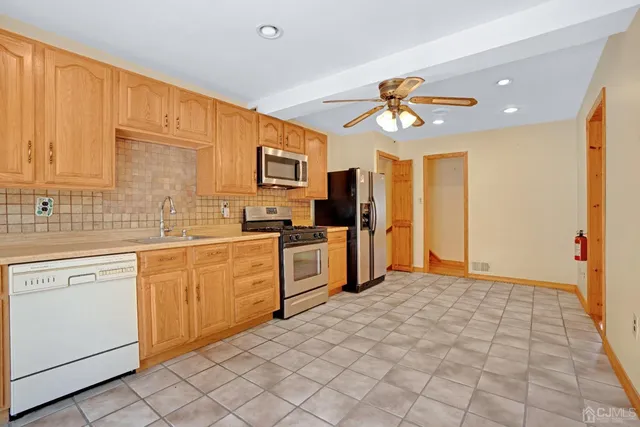 a kitchen with a stove a sink and a refrigerator