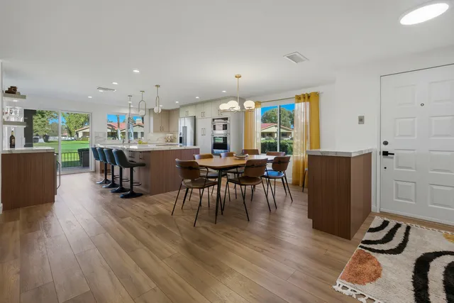 a view of a dining room with furniture window and wooden floor